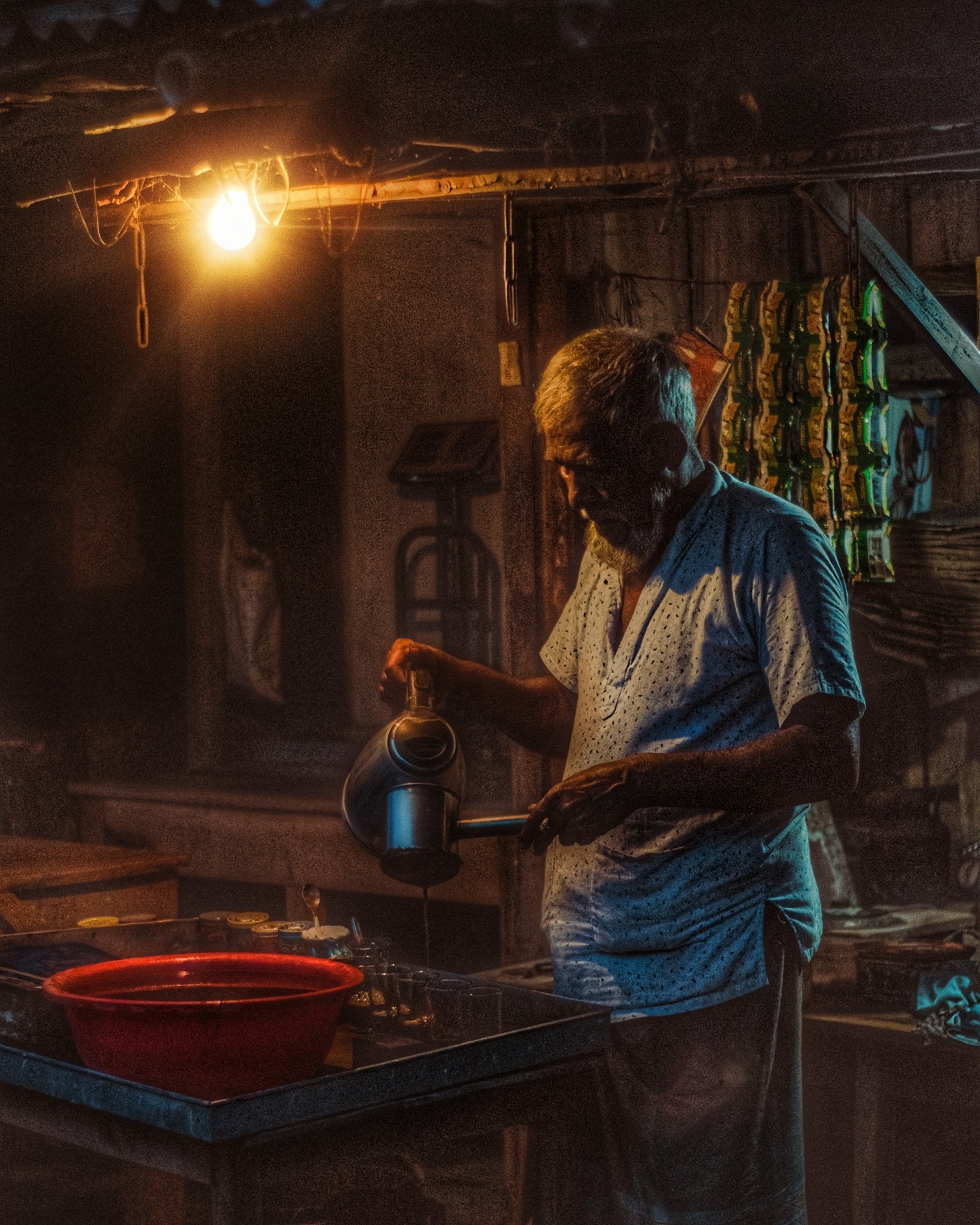 A tea-stall owner preparing cha