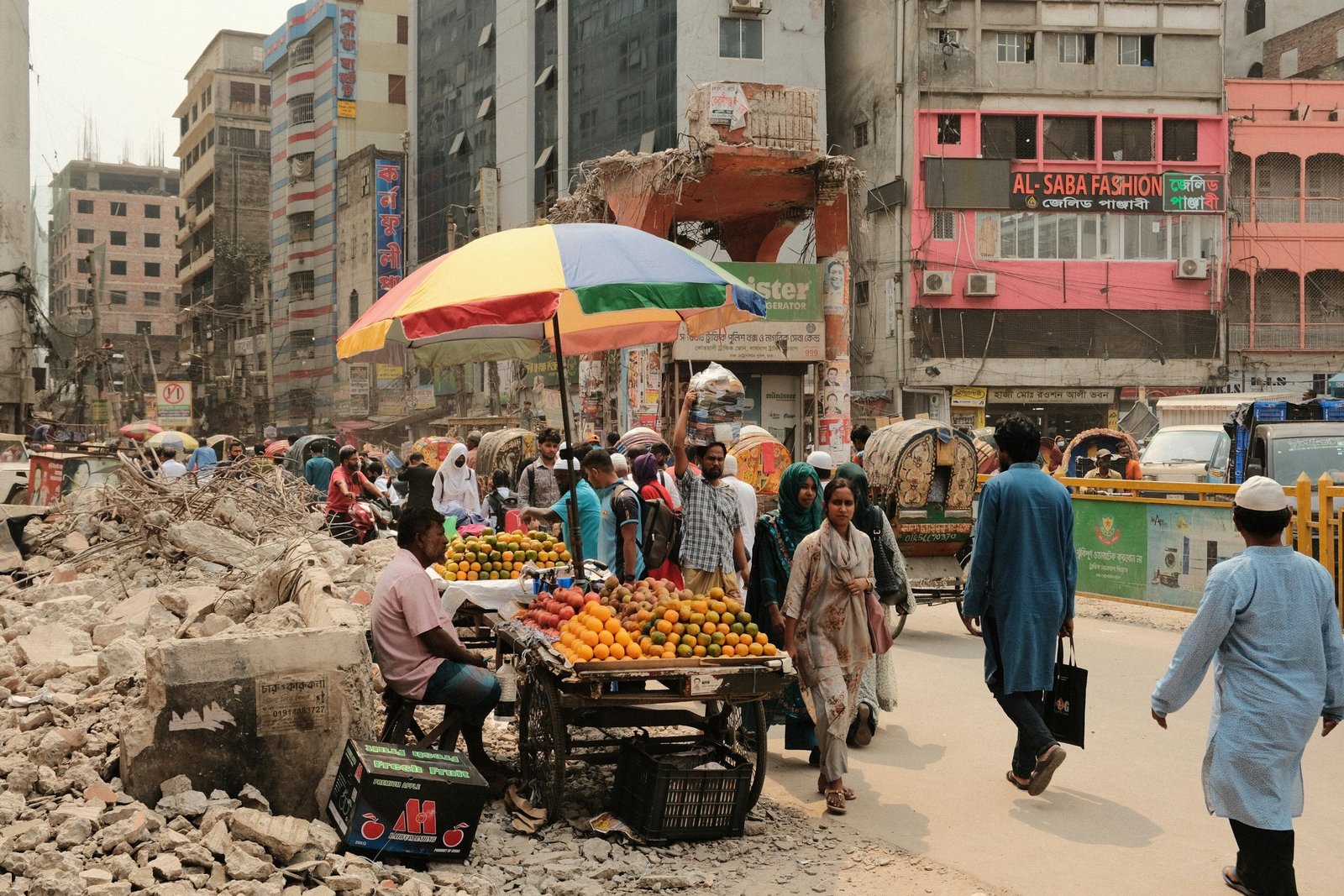 A busy Dhaka street market with fruit stalls